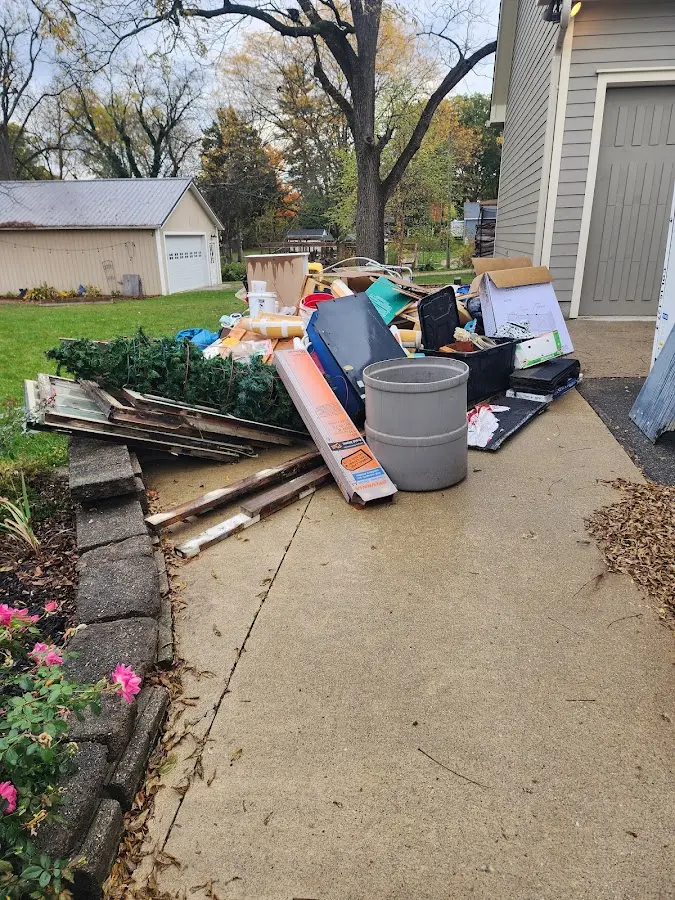 Dumpster being loaded with debris for 10 Yard Dumpster Rental in Royalton